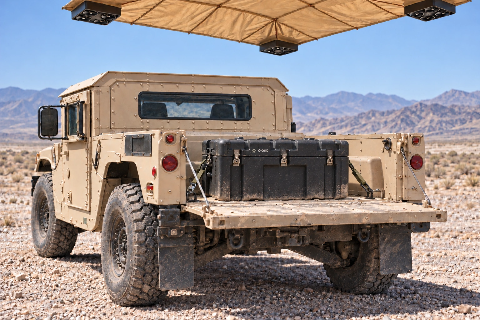A closed Vigil case secured in a Humvee cargo bed beneath Air Cover in the desert